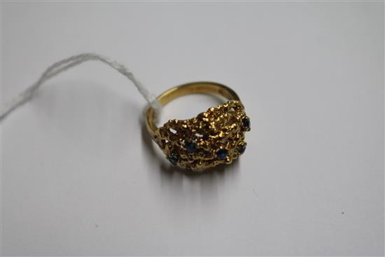 A 1960s 18ct gold and sapphire set pierced nugget ring, size M.